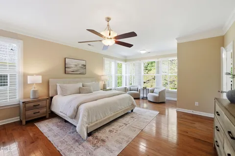 a view of an entryway with wooden floor a fireplace and a chandelier