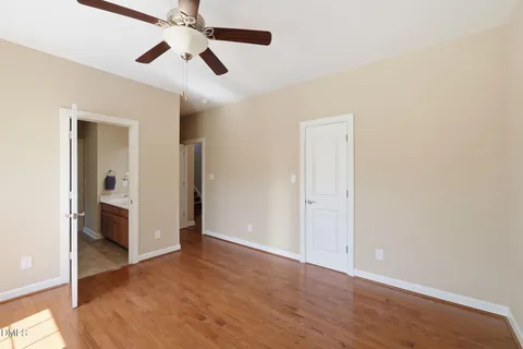 a view of a livingroom with a ceiling fan and window