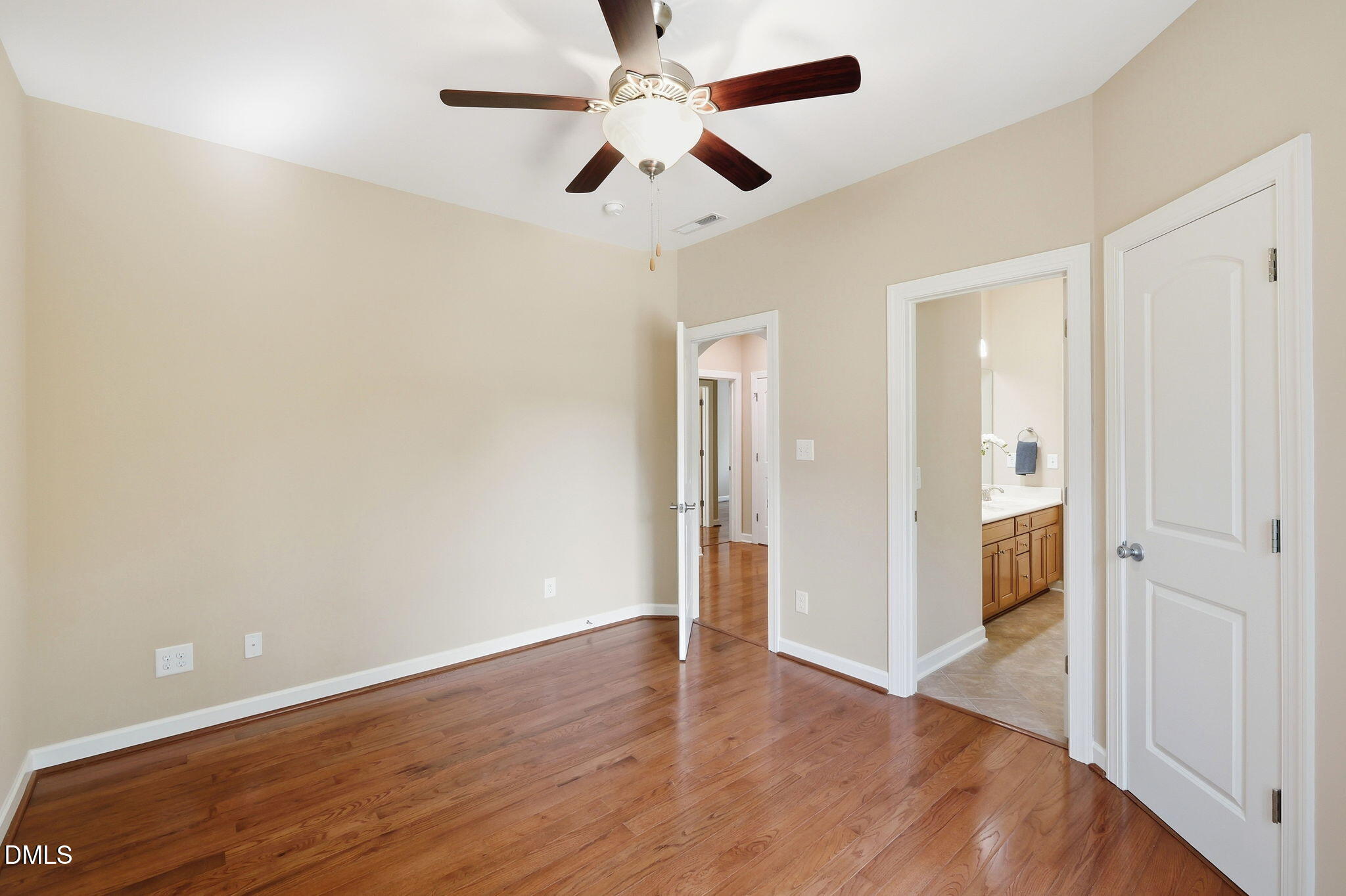 804 Long Meadows Road Chapel Hill, NC 27516 - Photo 32 of 50 an empty room with wooden floor a ceiling fan and closet