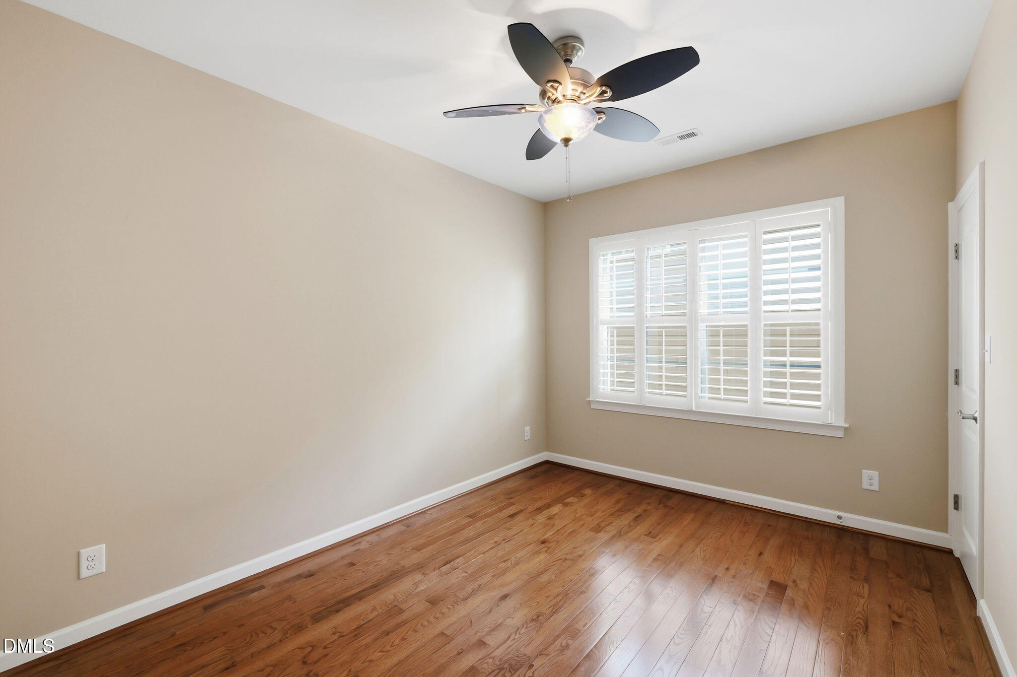804 Long Meadows Road Chapel Hill, NC 27516 - Photo 34 of 50 an empty room with a window and wooden floor