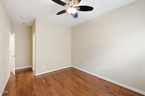 an empty room with a window and wooden floor