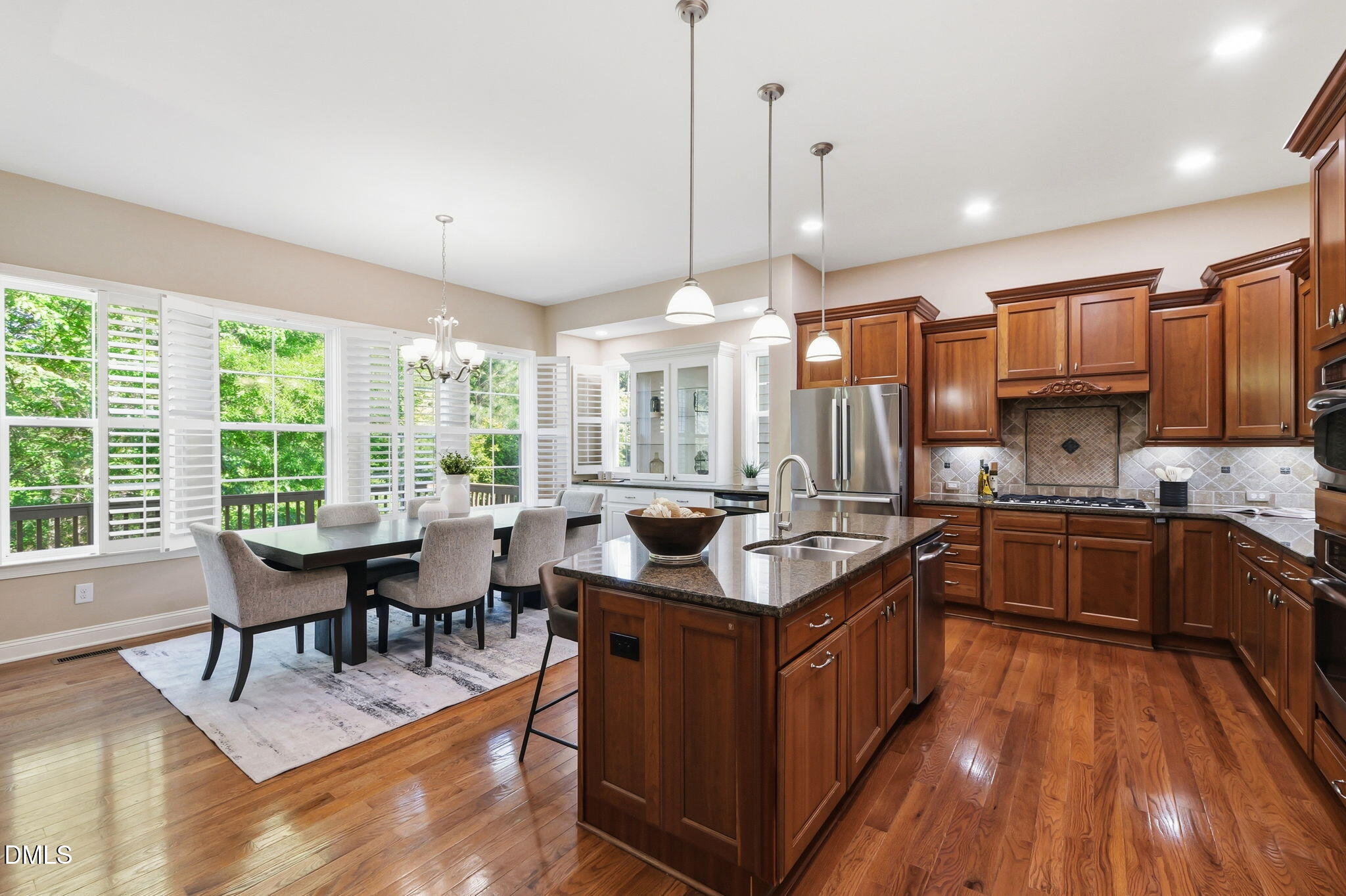 804 Long Meadows Road Chapel Hill, NC 27516 - Photo 7 of 50 a kitchen with stainless steel appliances granite countertop sink stove and wooden floor