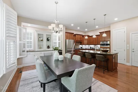 a kitchen with stainless steel appliances granite countertop sink stove and wooden floor