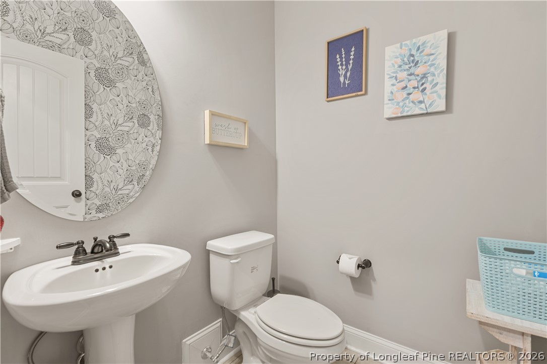137 Minter School Road Sanford, NC 27332 - Photo 19 of 50 a bathroom with a toilet sink and mirror