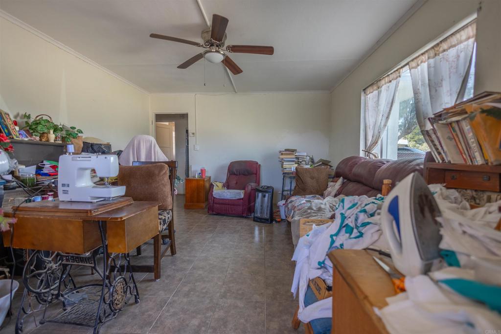 13765 Fremont Street Trona, CA 93562 - Photo 15 of 31 a room with furniture a chandelier fan and a window