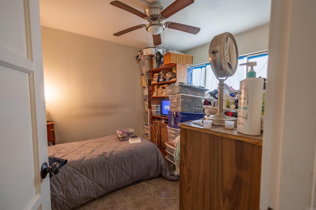 13765 Fremont Street Trona, CA 93562 - Photo 22 of 31 a bed room with a bed and a chandelier