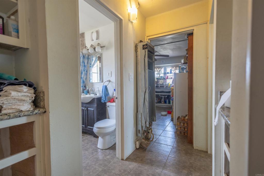 13765 Fremont Street Trona, CA 93562 - Photo 25 of 31 a view of a hallway with wooden floor and a dining room