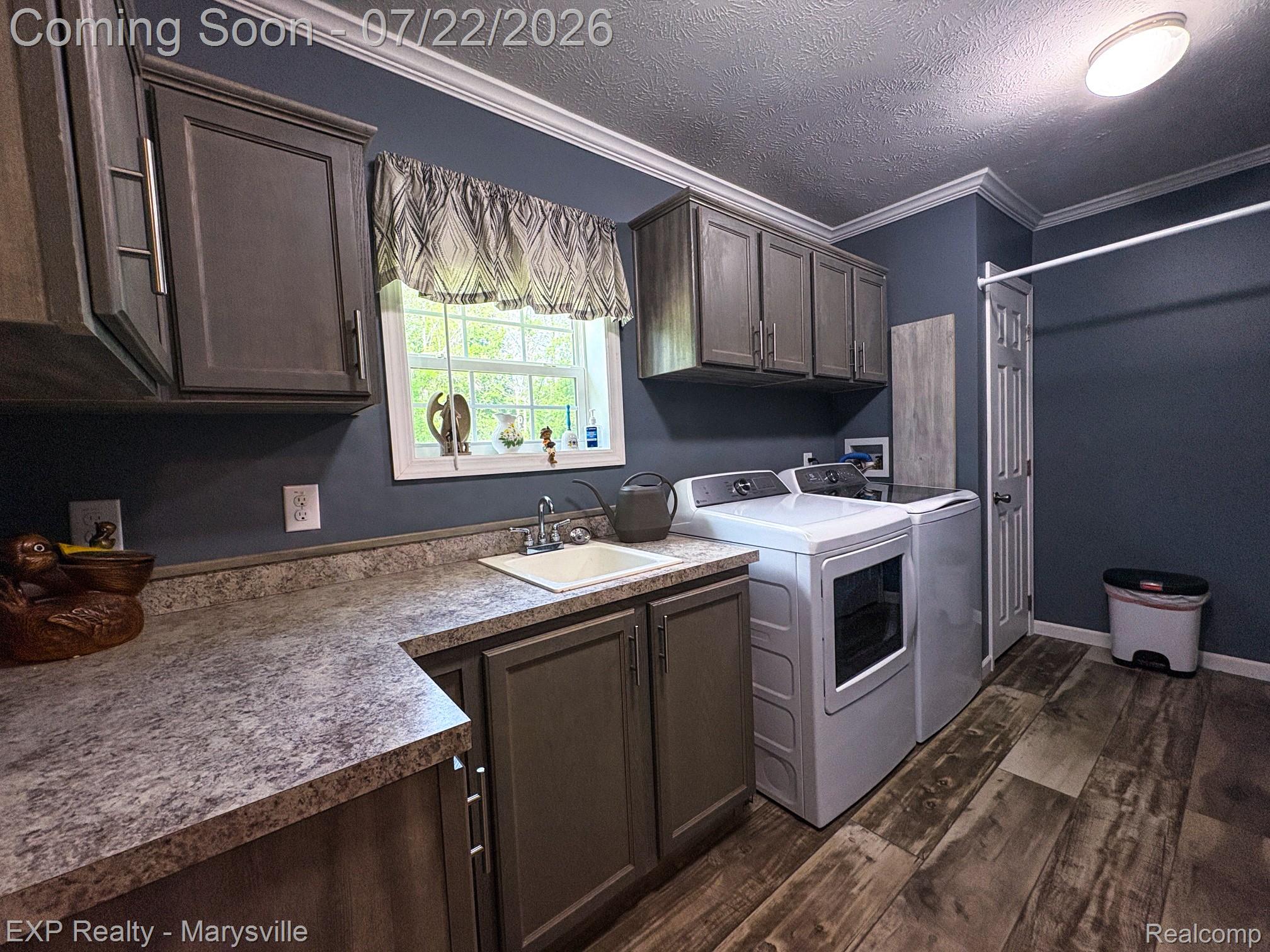 2601 Beach Road Port Huron, MI 48060 - Photo 28 of 34 Functional utility room featuring wood-finish flooring and crown molding