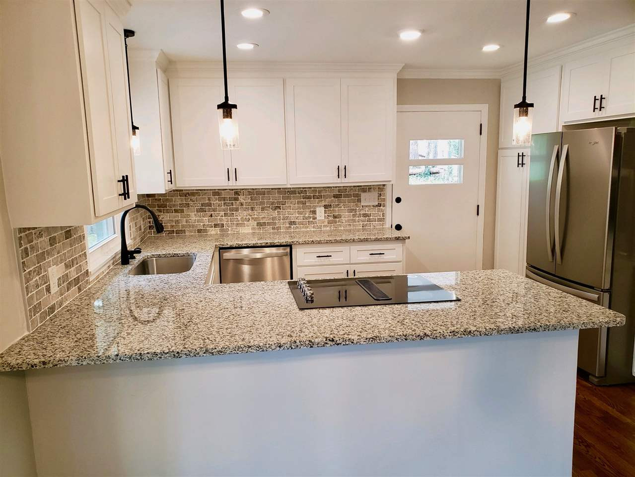 611 Wofford Road Durham, NC 27707 - Photo 11 of 30 Built in Wall Oven, Downdraft cooktop, extended bar, deep single sink, new dishwasher, new fixtures, bright open space to all living spaces. New solid wood doors facing with original solid wood cabinets, french door refrigerator and cabinets galore Custom Kitchen