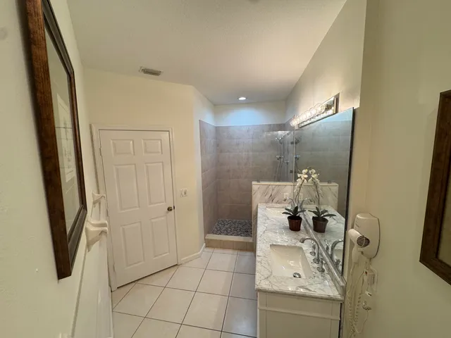 a bathroom with a shower and mirror