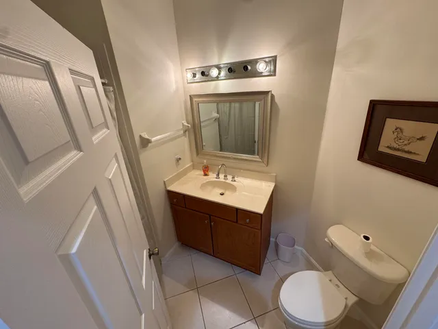 a bathroom with a sink vanity mirror and toilet