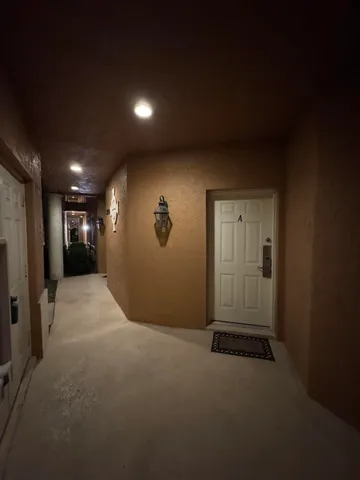 a view of hallway with wooden floor