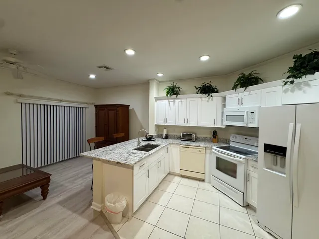 a kitchen with a stove a sink and a refrigerator
