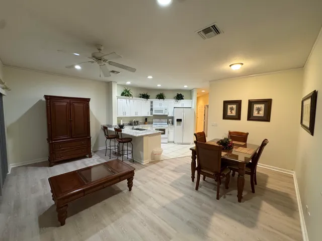 a living room with furniture and kitchen view