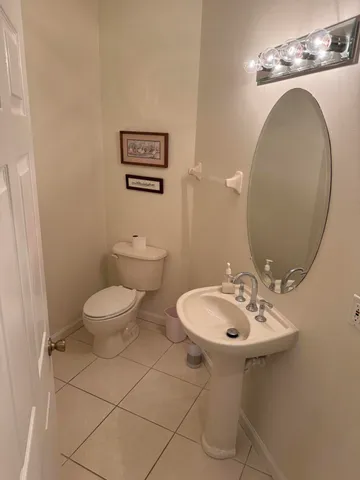 a bathroom with a sink mirror and toilet