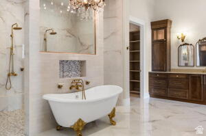 1141 East Lost Ridge Drive Washington, UT 84780 - Photo 64 of 108 Freestanding clawfoot tub with gold-tone fixtures, complemented by a walk-in shower featuring matching hardware