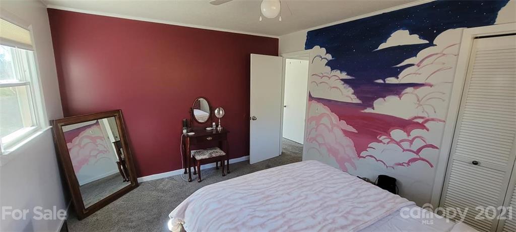 787 Cleghorn Mill Road Rutherfordton, NC 28139 - Photo 24 of 32 a bedroom with a bed and a mirror