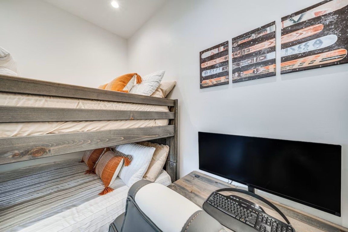 72 Meadow Trail, Unit 104 Fraser, CO 80442 - Photo 13 of 21 a bedroom with a bed and a television