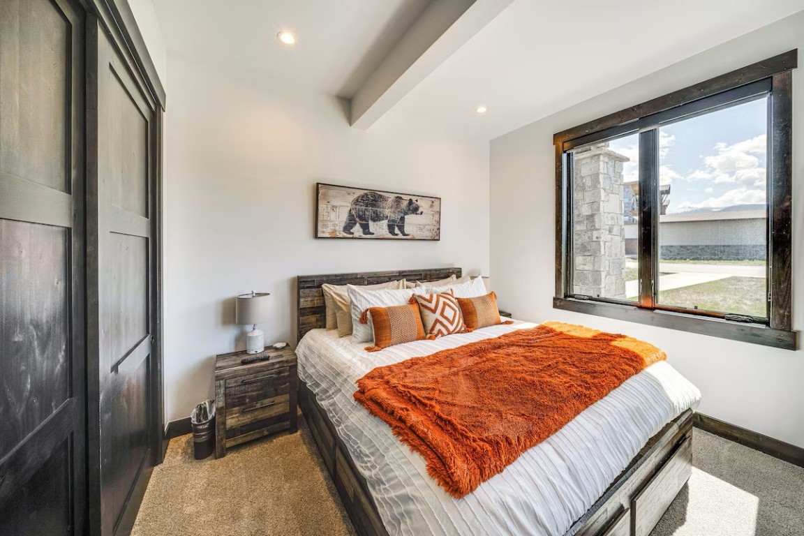 72 Meadow Trail, Unit 104 Fraser, CO 80442 - Photo 5 of 21 a bedroom with a large bed and a large window