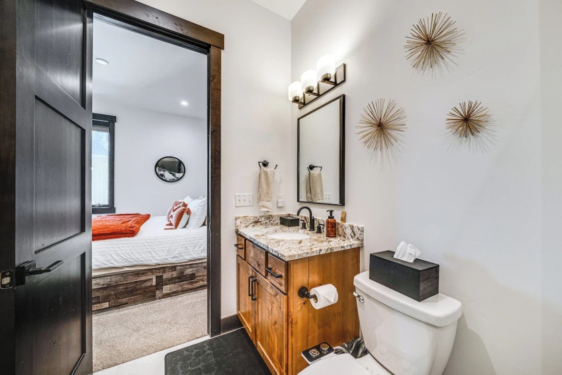72 Meadow Trail, Unit 104 Fraser, CO 80442 - Photo 9 of 21 a bathroom with a toilet sink and mirror