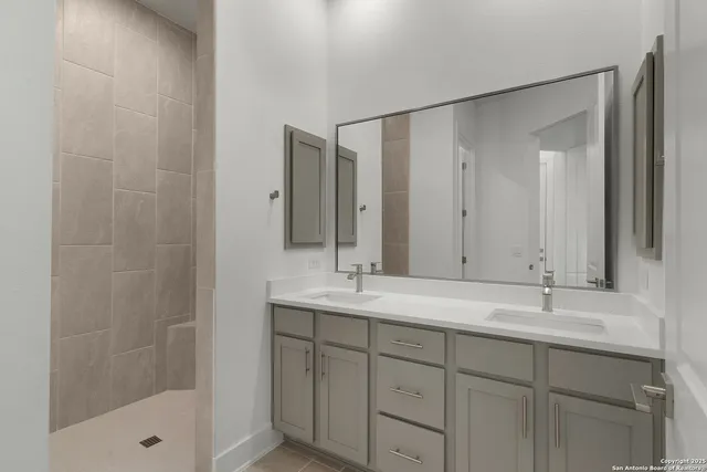 a bathroom with a shower sink and mirror