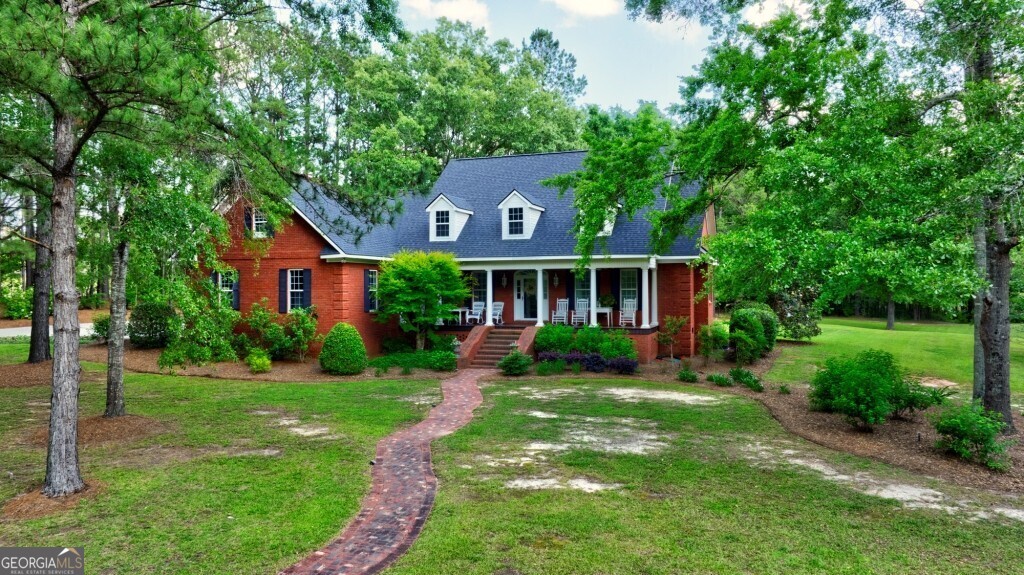 426 Wadley Coleman Lake Road Swainsboro, GA 30401 - Photo 1 of 79 a front view of a house with a yard and garage