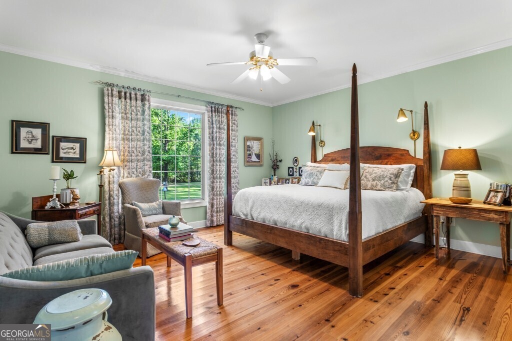 426 Wadley Coleman Lake Road Swainsboro, GA 30401 - Photo 33 of 79 a bedroom with a bed and wooden floor