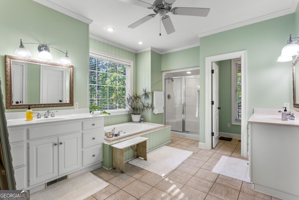 426 Wadley Coleman Lake Road Swainsboro, GA 30401 - Photo 34 of 79 a bathroom with a double vanity sink toilet mirror and bathtub