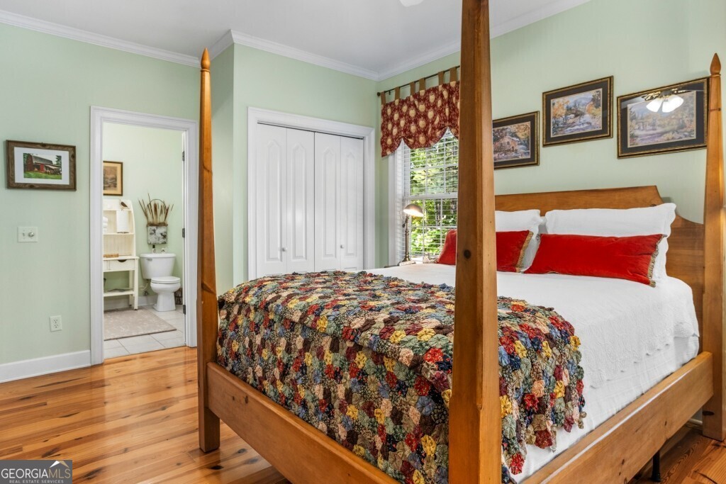 426 Wadley Coleman Lake Road Swainsboro, GA 30401 - Photo 35 of 79 a bedroom with a bed and wooden floor