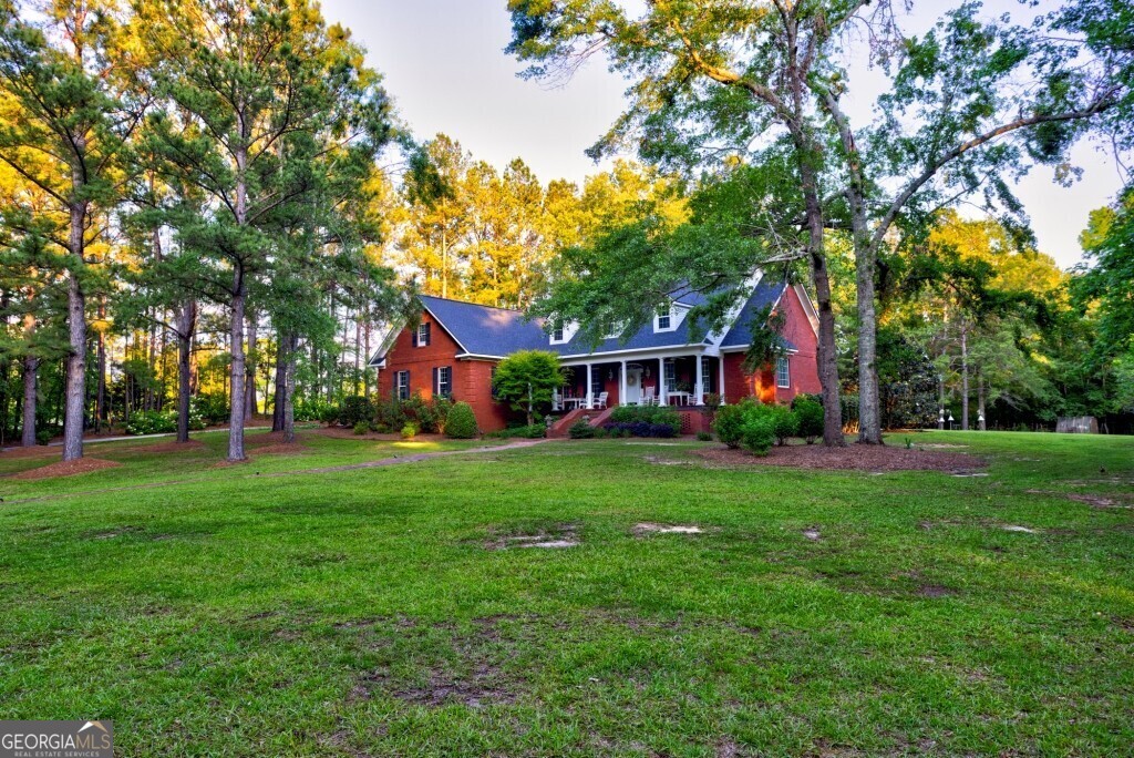 426 Wadley Coleman Lake Road Swainsboro, GA 30401 - Photo 6 of 79 a front view of a house with yard and green space
