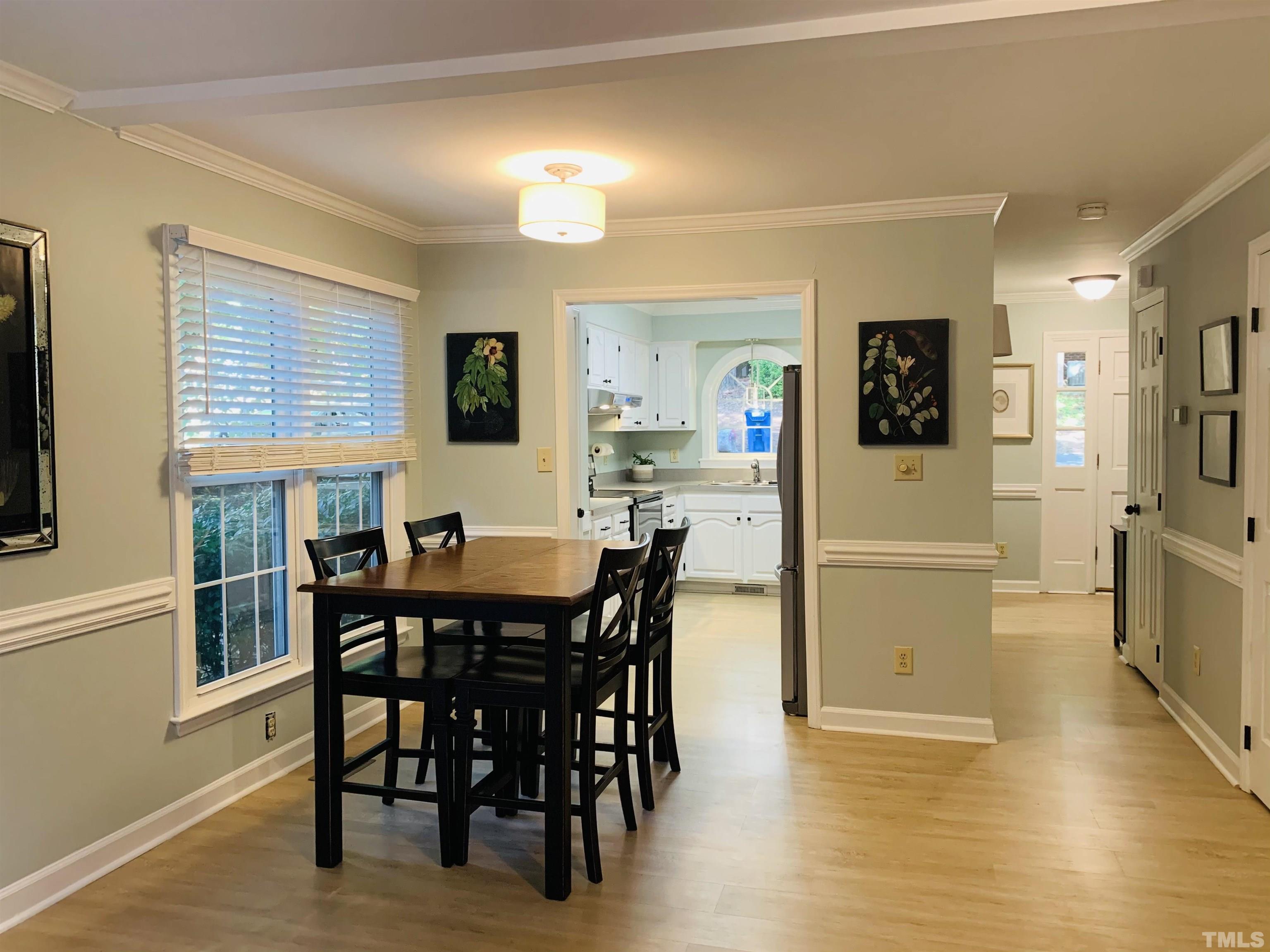 4609 Hershey Court Raleigh, NC 27613 - Photo 23 of 26 a view of a dining room with furniture and wooden floor
