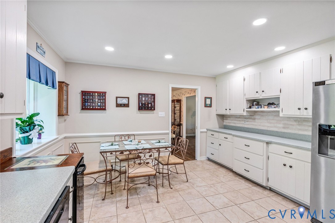 5700 Elfinwood Road Chester, VA 23831 - Photo 15 of 38 a kitchen with granite countertop white cabinets and stainless steel appliances