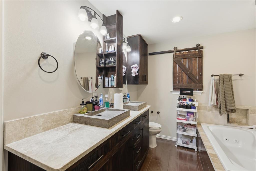 324 Bowie Street Forney, TX 75126 - Photo 15 of 25 a bathroom with a sink vanity tub and a mirror