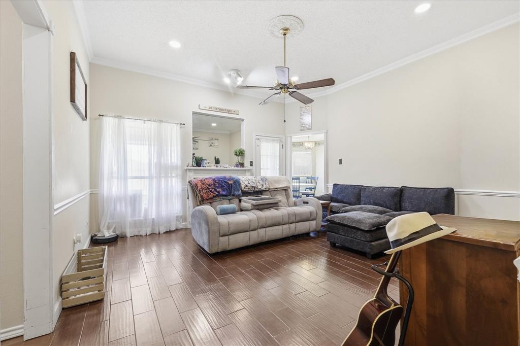 324 Bowie Street Forney, TX 75126 - Photo 2 of 25 a living room with furniture and a wooden floor