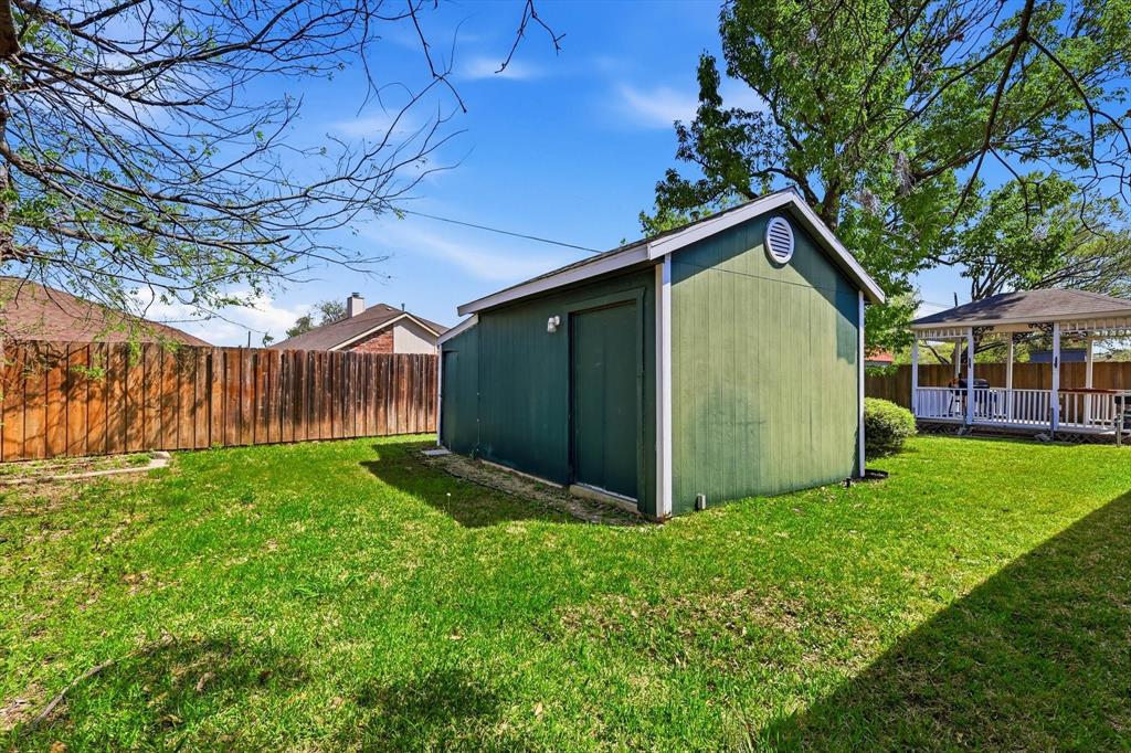 324 Bowie Street Forney, TX 75126 - Photo 25 of 25 a view of an house with backyard space and garden