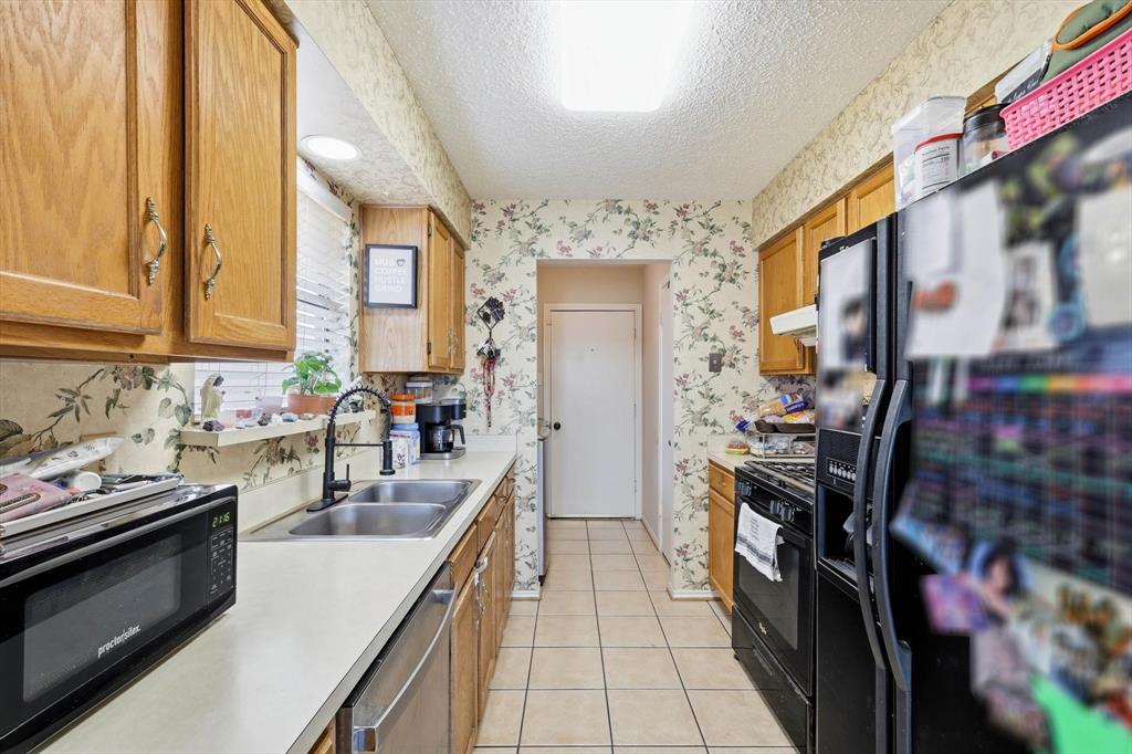 324 Bowie Street Forney, TX 75126 - Photo 6 of 25 a kitchen with lots of counter top space and stainless steel appliances