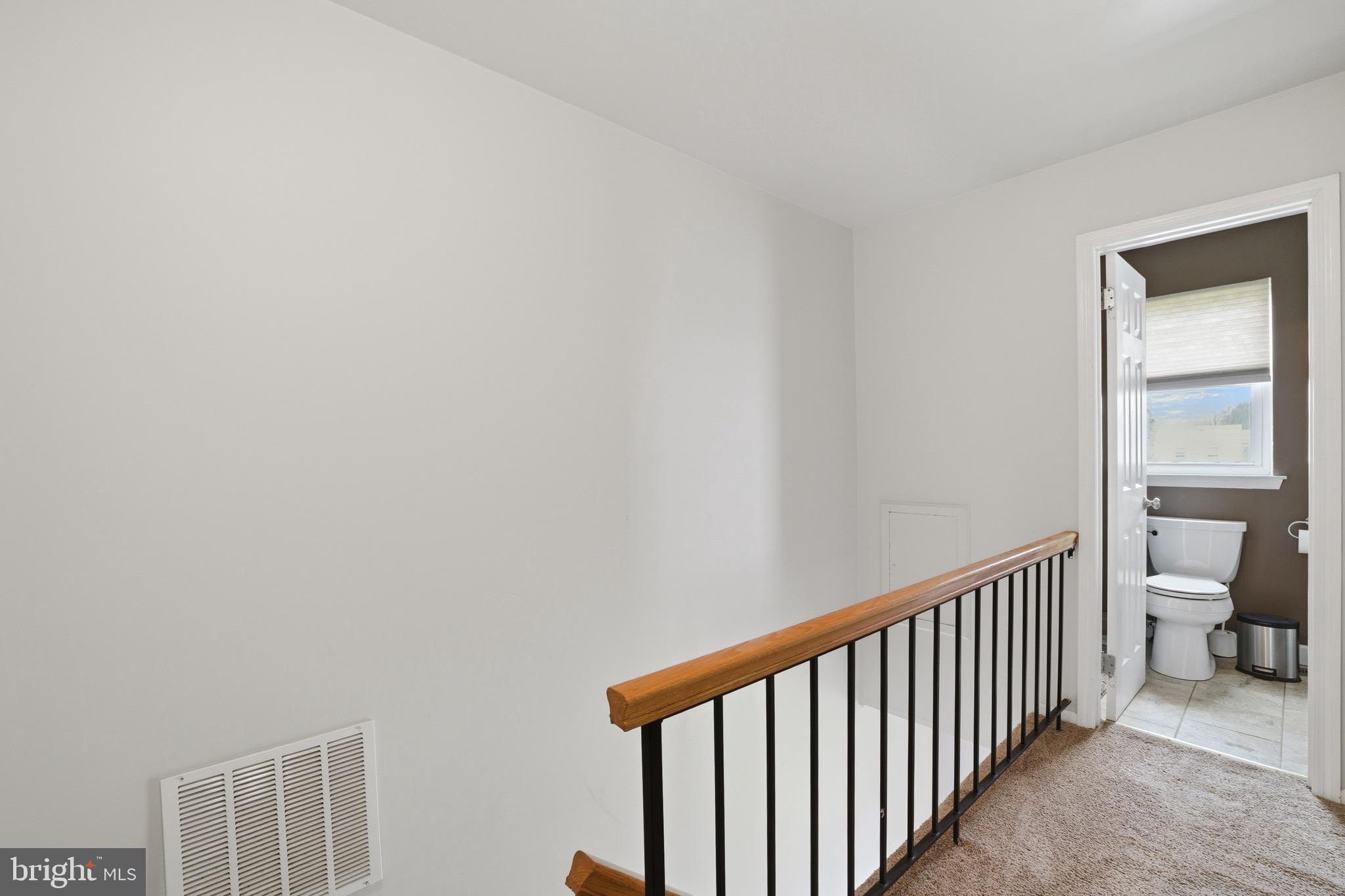 14 Woodhurst Drive Mount Holly, NJ 08060 - Photo 14 of 24 a view of a hallway with white toilet and a window