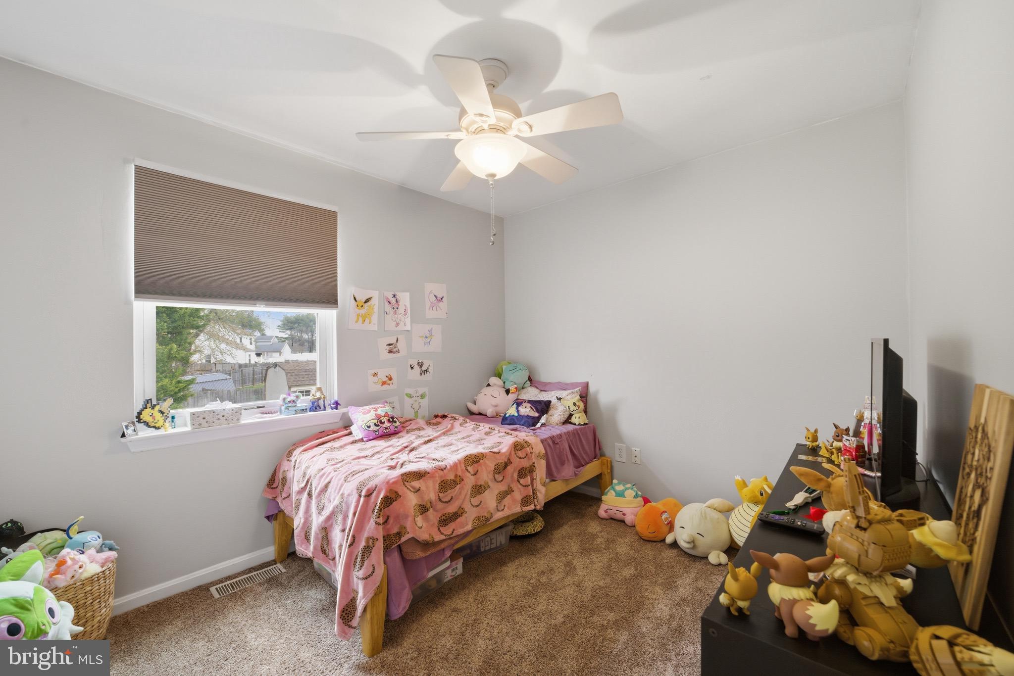 14 Woodhurst Drive Mount Holly, NJ 08060 - Photo 22 of 24 a bed sitting in a bedroom next to a window