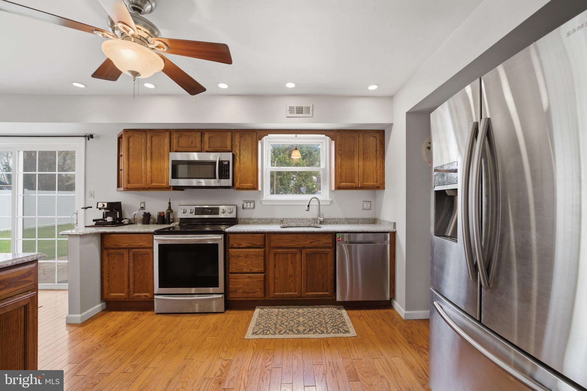 14 Woodhurst Drive Mount Holly, NJ 08060 - Photo 7 of 24 a kitchen with stainless steel appliances granite countertop a stove refrigerator and microwave