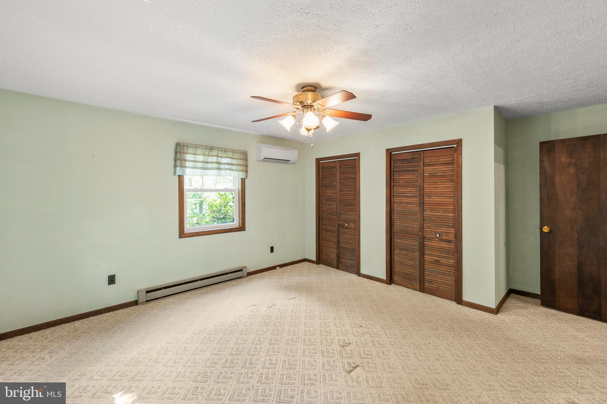 170 Frye Path Road Gore, VA 22637 - Photo 17 of 50 an empty room with windows and fan
