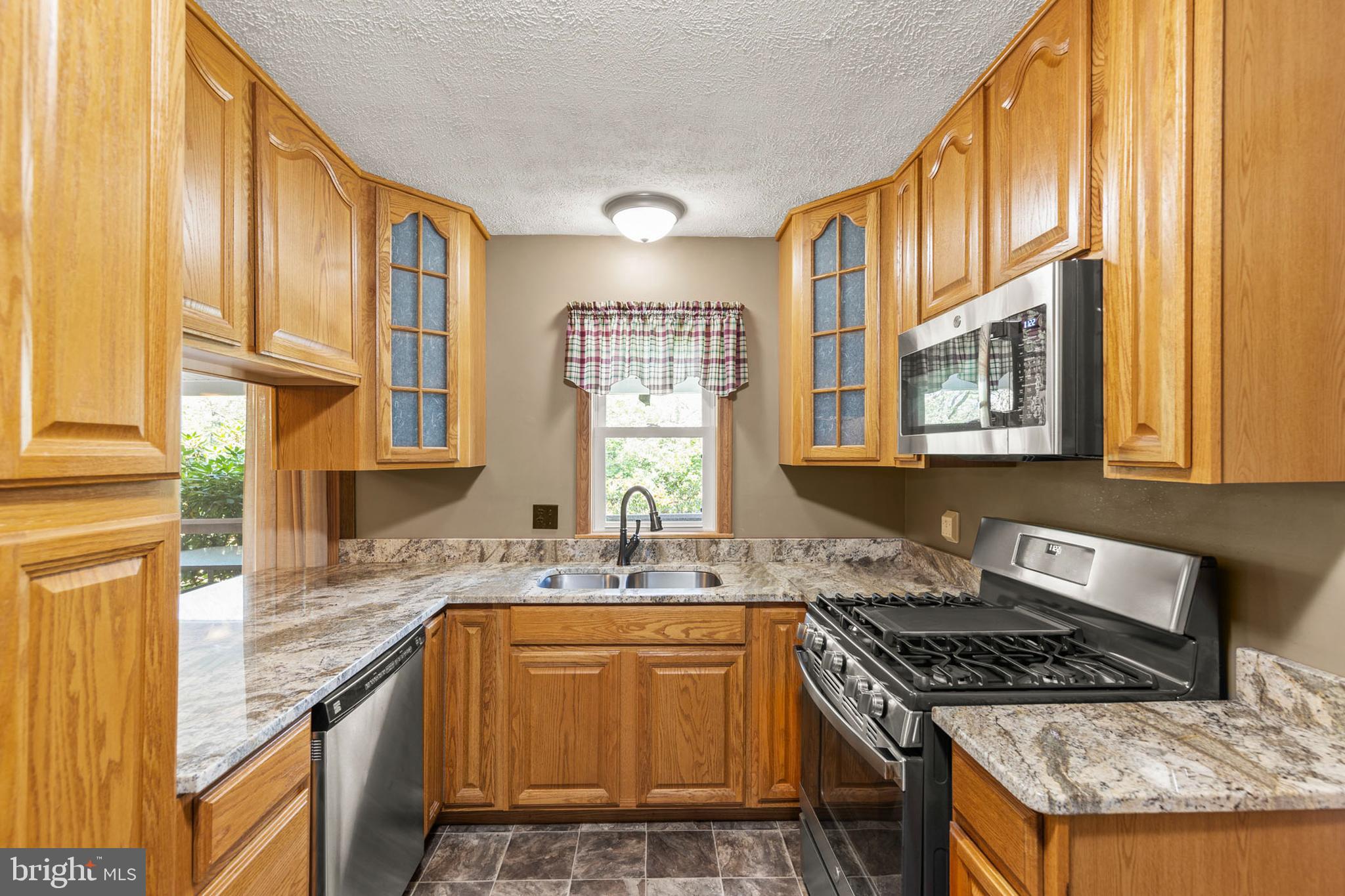 170 Frye Path Road Gore, VA 22637 - Photo 8 of 50 a kitchen with stainless steel appliances granite countertop a stove a sink and a microwave