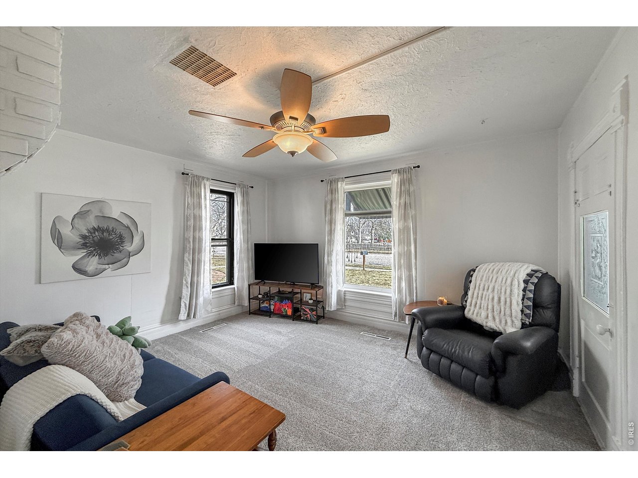 837 5th Street Berthoud, CO 80513 - Photo 12 of 36 a living room with furniture and a flat screen tv