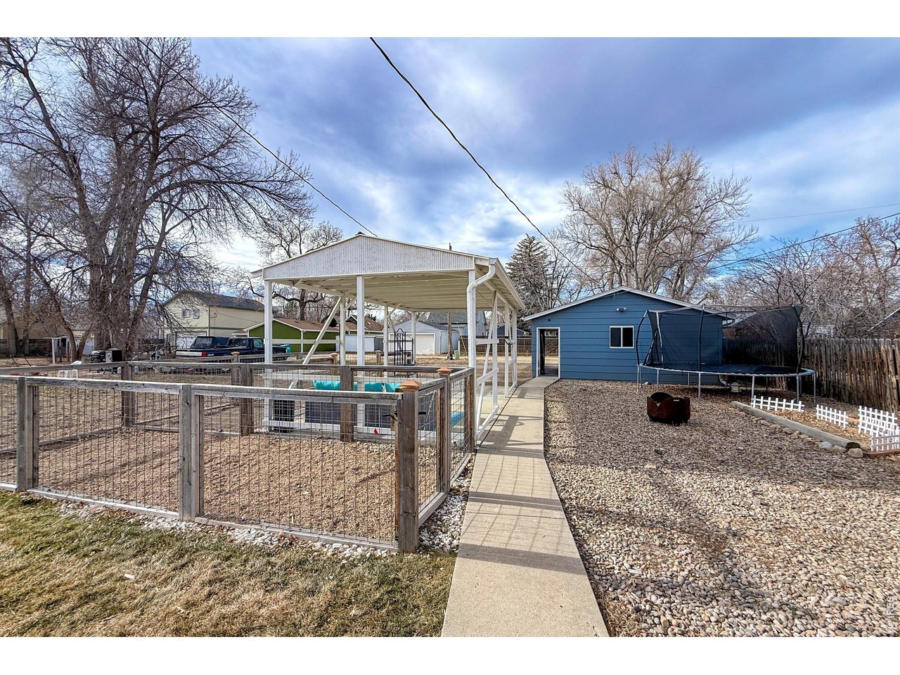 837 5th Street Berthoud, CO 80513 - Photo 26 of 36 a view of a house with a yard covered in snow