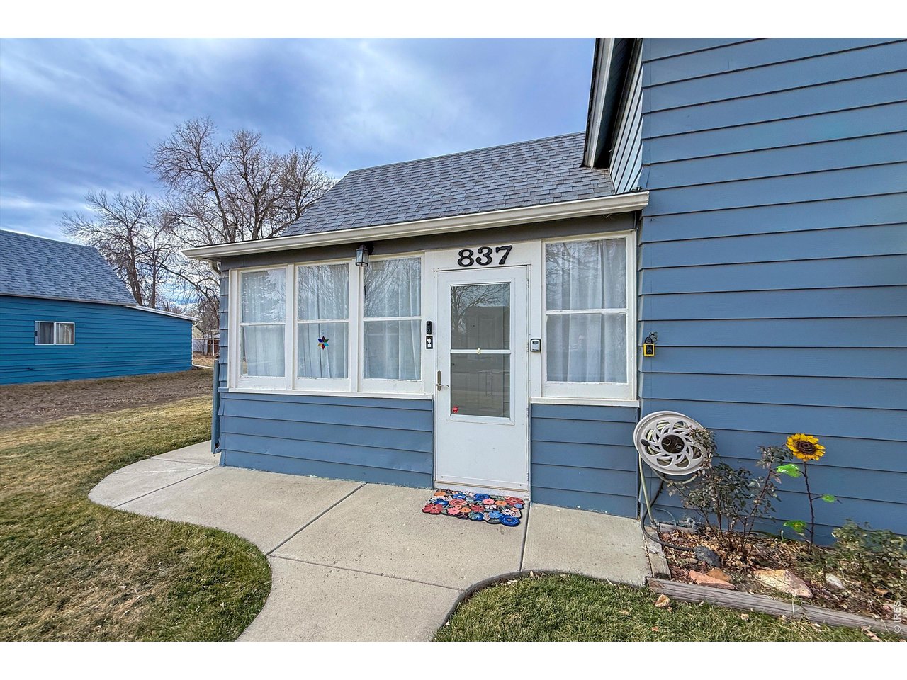 837 5th Street Berthoud, CO 80513 - Photo 3 of 36 a front view of a house with garden