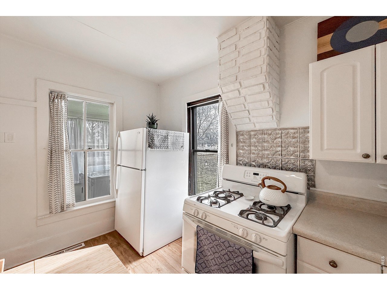 837 5th Street Berthoud, CO 80513 - Photo 7 of 36 a kitchen with a stove a refrigerator and a sink
