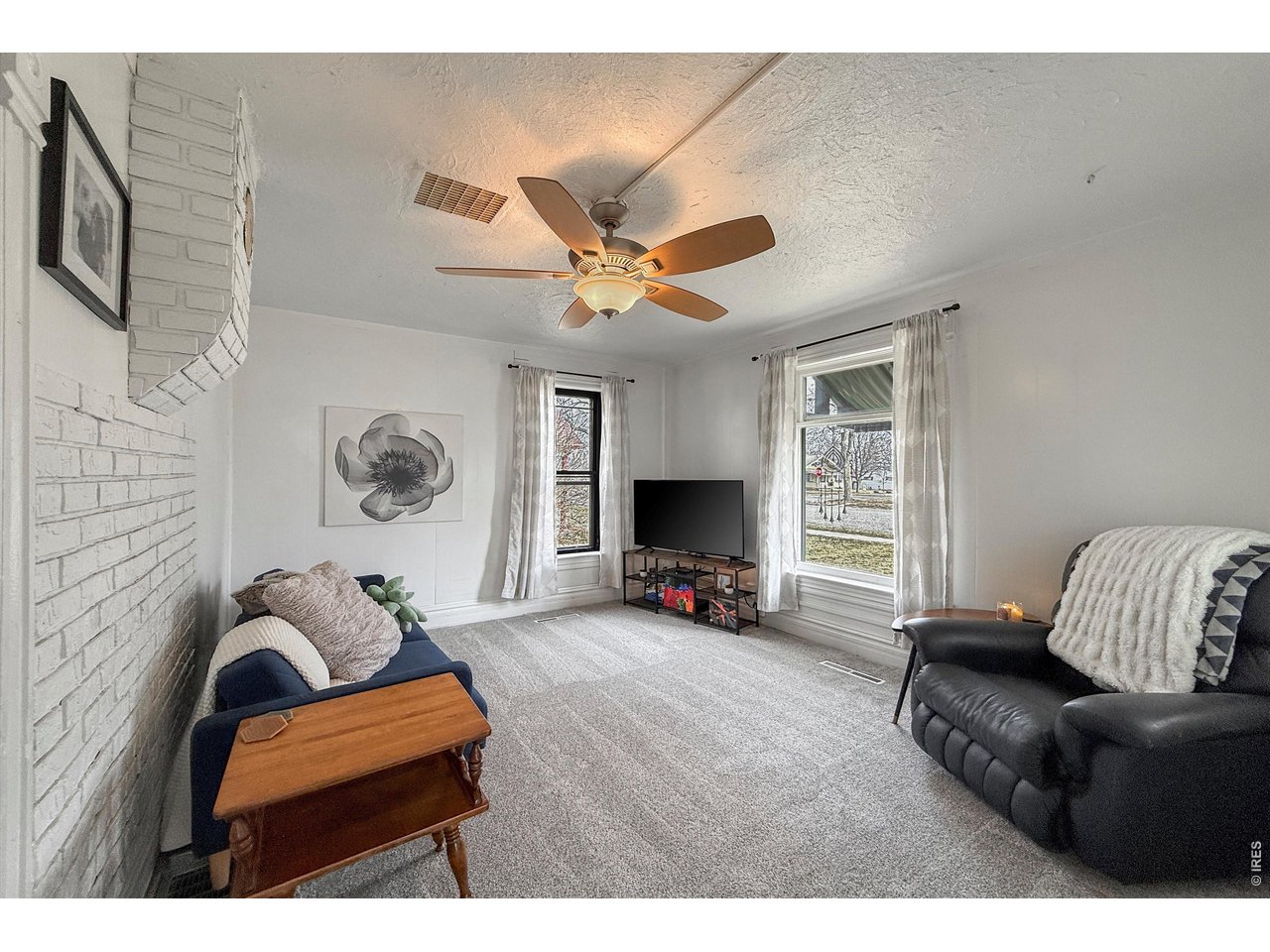 837 5th Street Berthoud, CO 80513 - Photo 10 of 36 a living room with furniture and a flat screen tv