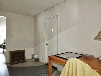 a bedroom with a bed and a mirror