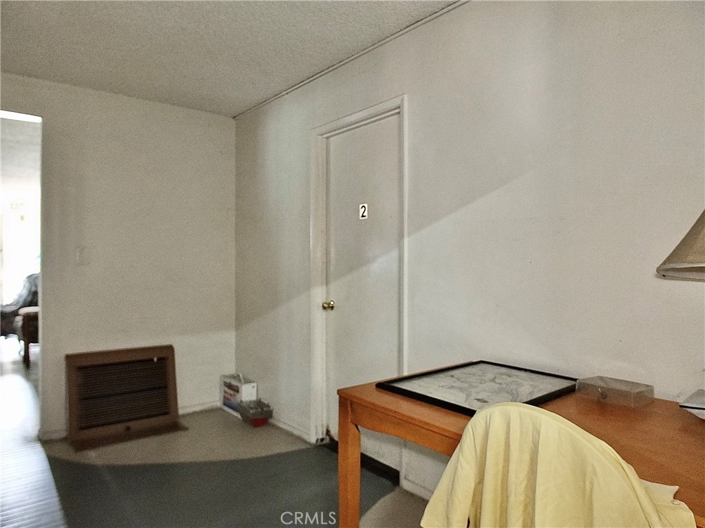 836 Atlantic Avenue Long Beach, CA 90813 - Photo 15 of 27 a bedroom with a bed and a mirror