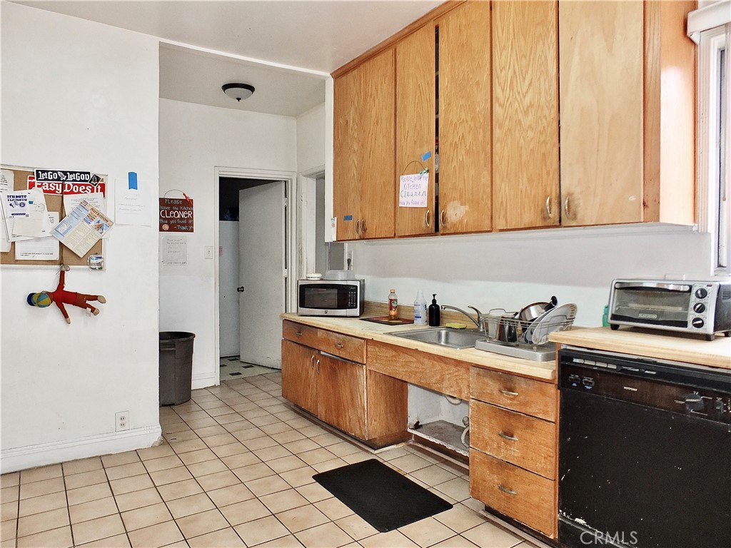 836 Atlantic Avenue Long Beach, CA 90813 - Photo 18 of 27 a kitchen with stainless steel appliances granite countertop a stove a sink and a refrigerator