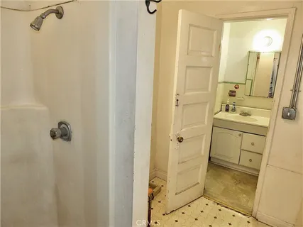 a bathroom with a sink mirror and shower